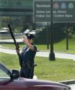 A Port Authority of New York and New Jersey police officer with a shotgun signals a motorists to stop at a blockaded entrance at Newark Airport in Newark, N.J., Wednesday, Sept. 12, 2001. All airports in the U.S. remained closed following terrorist attacks Tuesday, Sept. 11, 2001, at the World Trade Center in New York and the Pentagon in Washington. (AP Photo/Daniel Hulshizer)