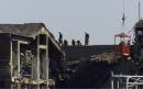 Firefigters survey the  roof at the Pentagon, Wednesday, Sept 12, 2001, as they work to put out fires caused by a hijacked airliner after it crashed into the building Tuesday. (AP Photo/Hillery Smith Garrison)