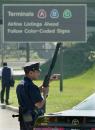 A police officer of the Port Authority of New York and New Jersey, signals a motorist to keep moving past a closed entrance at Newark Airport in Newark, N.J., Wednesday, Sept. 12, 2001. All airports in the country remained closed Wednesday morning, following Tuesday's attacks at the World Trade Center and the Pentagon. (AP Photo/Daniel Hulshizer)