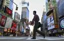 A man crosses an empty intersection in New York's Times Square, Wednesday, Sept. 12, 2001.  City streets are deserted in the wake of the two hijacked airliners that crashed into the World Trade Center towers on Tuesday, Sept. 11, destroying both buildings. City officials asked non-essential workers to stay home and closed city schools. (AP Photo/Robert F. Bukaty)