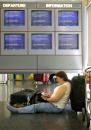 Margie Smith of Portland, Ore., waits for a return flight home at Chicago's O'Hare Aiport, Wednesday Sept. 12, 2001. Smith and her daughter had spent a week in New York, visiting the World Trade Center on Monday.  She had changed planes in Chicago and was bound for Oregon Tuesday, when their plane was turned around as air service in the United States was halted after attacks on New York and on Washington. (AP Photo/Charles Bennett)