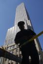 A police officer stands guard at a barricade outside the Empire State Building in New York on Wednesday, Sept. 12, 2001, a day after the suspected terrorist attack on the World Trade Center. Streets, a block east and west of the high profile building, were closed to pedestrian and vehicle traffic. (AP Photo/Amy Sancetta)