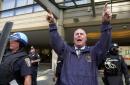 A Boston police officer gestures for people to clear the entrance to the Westin Hotel in downtown Boston Wednesday, Sept. 12, 2001 as officers and SWAT team members leave after a team of FBI agents searching for suspects in the terrorist attacks in New York and Washington stormed the hotel. Authorities reportedly arrested three people. (AP Photo/Elise Amendola)