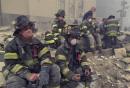 Firemen take a break near the site of the World Trade Center in New York, Wednesday, Sept. 12, 2001.  In the most devastating terrorist onslaught ever waged against the United States, knife-wielding hijackers crashed two airliners into the World Trade Center on Tuesday, toppling its twin 110-story towers.  (AP Photo/Mark Lennihan)