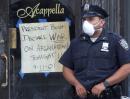 A policeman stands near a sign outside a restaurant urging President Bush to declare war on Afghanistan, in New York, Wednesday, Sept. 12, 2001.  In the most devastating terrorist onslaught ever waged against the United States, knife-wielding hijackers crashed two airliners into the World Trade Center on Tuesday, toppling its twin 110-story towers. (AP Photo/Paul Chiasson)