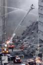 Rescue workers and vehicles are deployed near the site of the World Trade Center in New York, Wednesday, Sept. 12, 2001.  In the most devastating terrorist onslaught ever waged against the United States, knife-wielding hijackers crashed two airliners into the World Trade Center on Tuesday, toppling its twin 110-story towers.(AP Photo/ Beth A. Keiser)