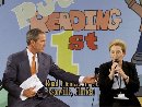 President George W. Bush passes a microphone to Diane Gillespie, Principal of Justina Elementary School during a 'Leadership Forum' on childhood reading in Jacksonville, Florida September 10, 2001. Bush called for a 'war on illiteracy' as he made a pitch for his education proposals even as worries about the weak economy began to push them down the political agenda.  (Win McNamee/Reuters)