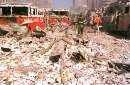 Rubble, papers and metal are strewn all over lower Manhattan near the World trade Center buildings following their collapse, September 11, 2001. New York City fire trucks are damaged as well.   REUTERS/Anthony Correia