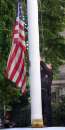 City of Seattle security guard Dion Fernandez completely lowers the American flag at the City municipal parking structure in downtown Seattle, Washington on September 11, 2001. In the worst attack on American soil since Pearl Harbor, three hijacked planes slammed into the Pentagon and New York's landmark World Trade Center on Tuesday, demolishing the two 110-story towers that symbolize U.S. financial might. The attacks brought normal life across the United States to a standstill, turning the major cities of the nation into eerie ghost towns. All financial markets were closed, millions of workers sent home early, all flights around the nation were canceled and all airports shut in an unprecedented moveREUTERS/Anthony P. Bolante