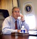 U.S.President George W. Bush talks on the phone with New York Mayor Rudy Guiliani and New York Governor George Pataki aboard Air Force One during a flight following a statement regarding the two planes that crashed into the World Trade Center in New York City, September 11, 2001.  REUTERS/Pool/Doug Mills