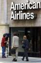 A television photographer shoots into a closed American Airlines office in the Chicago loop, September 11, 2001, following the terrorist attack in New York. As  airlines were used as a tool of the attack, all air travel was suspended. Three hijacked planes crashed into major U.S. landmarks on Tuesday, destroying both of New York's mighty twin towers and plunging the Pentagon in Washington into flames, in an unprecedented assault on key symbols of U.S. military and financial power.     REUTERS/Sue Ogrocki