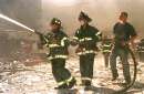 New York City firefighters battle blaze on Vessey and Greenwich Streets after the World Trade Center buildings collapse September 11, 2001. Three hijacked planes crashed into major U.S. landmarks on Tuesday, destroying both of New York's mighty twin towers and plunging the Pentagon in Washington into flames, in an unprecedented assault on key symbols of U.S. military and financial power.       REUTERS/Anthony Correia