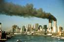 The towers of the World Trade Center pour smoke shortly after being struck by hijacked commercial airplanes in New York on September 11, 2001.  Three hijacked planes slammed into the Pentagon and New York's landmark World Trade Center on Tuesday, demolishing the two 110-story towers that symbolize U.S. financial might.  The East River and Manhattan Bridge are in the foreground.   REUTERS/Brad Rickerby