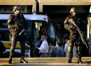 Sheriffs officers guard the Middlesex Superior Courthouse in Cambridge, Massachusetts, September 11, 2001 as prisoners are moved out in response to the terrorist attacks on the United States earlier in the day. In the worst attack on American soil since Pearl Harbor, three hijacked planes slammed into the Pentagon and New York's landmark World Trade Center on Tuesday, demolishing the two 110-story towers that symbolize U.S. financial might.      REUTERS/Brian Snyder