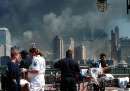 Emergency personnel tend to injured people in Liberty Park after two hijacked commercial planes slammed into the twin towers of New York's World Trade Center September 11, 2001, causing both 110-story landmarks to collapse in devastating clouds of flames and smoke and killing a 'tremendous number' of people. The unprecedented deadly attacks, believed to be coordinated terrorist acts aimed at the heart of the nation's financial district, paralyzed business and would keep markets closed at least through Wednesday, just one measure of the attack's stunning impact. REUTERS/Miguel Juarez