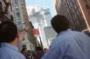 Pedestrians react to the World Trade Center collapse September 11, 2001. Two commercial airplanes crashed into the World Trade Center earlier.     REUTERS/Richard Cohen