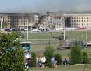 Members of the media and onlookers look at the destruction of the Pentagon in Arlington September 11, 2001, which was damaged by an aircraft earlier in the day. Both New York City's World Trade Center and the Pentagon were targets of terrorists today.  REUTERS/Molly Riley