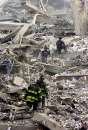 Firefighters comb the remains of the World Trade Center after the collapse September 11, 2001. Two hijacked commercial planes crashed into the World Trade Center earlier.    REUTERS/Peter Morgan