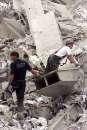 Firefighters comb the remains of the World Trade Center after the collapse September 11, 2001. In the worst attack on American soil since Pearl Harbor, three hijacked planes slammed into the Pentagon and New York's landmark World Trade Center on Tuesday, demolishing the two 110-story towers that symbolize U.S. financial might.     REUTERS/Peter Morgan