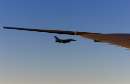 A F-16 fighter flies just off the wing of Air Force One on a flight back to Washington September 11, 2001. President George W. Bush returned to the White House where he will address the nation from the Oval Office about the terrorist attacks at the World Trade Center and the Pentagon.  REUTERS/Pool/Doug Mills