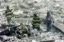 Firefighters comb the remains of the World Trade Center after the collapse September 11, 2001. Two hijacked commercial planes crashed into the World Trade Center earlier in the day.    REUTERS/Peter Morgan