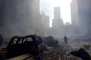 A firefighter walks amid rubble near the base of the destroyed World Trade Center in New York on September 11, 2001. In the worst terror attack on the U.S. mainland in modern history, two hijacked planes slammed into the twin towers of the World Trade Center in New York -- where about 40,000 people work -- and a third plane hit the Pentagon, across the Potomac river from Washington. The death toll, initially difficult to calculate, was expected to be in the thousands. REUTERS/Peter Morgan