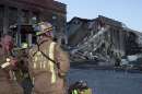 Fairfax County, Virginia, firefighters look at the gaping hole at the Pentagon building where American Airlines Flight 77 crashed into the building September 11, 2001. The World Trade Center towers in New York City were destroyed by terrorists who hijacked U.S. commerical airliners today. In the worst terror attack on the U.S. mainland in modern history, two hijacked planes slammed into the twin towers of the World Trade Center in New York -- where about 40,000 people work -- and a third plane hit the Pentagon, across the Potomac river from Washington.  REUTERS/William Philpott