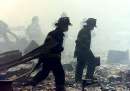 A group of firefighters walk amid rubble near the base of the destroyed World Trade Center in New York on September 11, 2001. Two hijacked commercial planes slammed into the twin towers of the World Trade Center Tuesday, causing both 110-story landmarks to collapse in thunderous clouds of fire and smoke and killing a 'tremendous number' of people starting their workday inside. REUTERS/Peter Morgan