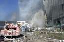 Fire trucks sit amid the rubble near the base of the destroyed World Trade Center in New York on September 11, 2001. In the worst terror attack on the U.S. mainland in modern history, two hijacked planes slammed into the twin towers of the World Trade Center in New York -- where about 40,000 people work -- and a third plane hit the Pentagon, across the Potomac river from Washington.  REUTERS/Peter Morgan