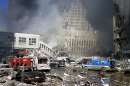 Fire trucks sit amid the rubble near the base of the destroyed World Trade Center in New York on September 11, 2001. Two hijacked commercial planes slammed into the twin towers of the World Trade Center Tuesday, causing both 110-story landmarks to collapse in thunderous clouds of fire and smoke and killing a 'tremendous number' of people starting their workday inside. REUTERS/Peter Morgan