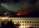 Flames seen after dark from the Pentagon in Arlington hours after a highjacked airliner crashed into the building September 11, 2001. A hijacked passenger plane smashed into the Pentagon Tuesday, setting off a huge explosion and fire and causing untold casualties in a devastating blow to the headquarters of the U.S. military. The attack, coinciding with similar incidents at the World Trade Center in New York, set off an immediate security alert in the American capital, with all federal buildings evacuated and F-16 fighter jets scrambled overhead.  REUTERS/Molly Riley