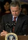 President George W. Bush asks for a moment of silence after the World Trade Center in New York was struck by two aircraft, September 11, 2001.  Bush condemned what he called an 'apparent terrorist attack' on the World Trade Center and pledged the U.S. government will 'hunt down' those responsible.  (Win McNamee/Reuters)