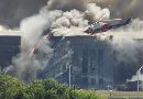 A rescue helicopter surveys damage to the Pentagon as firefighters battle flames after an airplane crashed into the U.S. military headquarters across the Potomac River from Washington, September 11, 2001. (Larry Downing/Reuters)