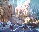 Pedestrians and police run as a tower of the World Trade Center collapses after two planes crashed into the complex September 11, 2001. Loss of life is expected to be catastrophic from the collapse of the giant towers where some 50,000 people work. (Reuters TV)