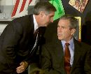 President George W. Bush listens as White House Chief of Staff Andrew Card informs him of a second plane hitting the World Trade Center while Bush was conducting a reading seminar at the Emma E. Booker Elementary School in Sarasota, Florida September 11, 2001. Bush made a brief statement before leaving the school. (Win McNamee/Reuters)