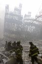 Firemen work around the remains of the World Trade Center after two planes crashed into the buildings causing them to collapse in New York on September 11, 2001. The two 110-story towers collapsed one at a time in a huge cloud of smoke and fire two hours after the initial impacts. (Peter Morgan/Reuters)