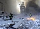 Firemen work around the World Trade Center after both towers collapsed in New York on September 11, 2001. Loss of life was expected to be catastrophic from the collapse of the giant towers, where roughly 40,000 people work. The two 110-story towers collapsed one at a time in a huge cloud of smoke and fire two hours after the initial impacts. (Peter Morgan/Reuters)