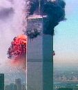 A fireball erupts from Tower 2 (rear, obscured by Tower 1) of the World Trade Center in New York after a hijacked airliner crashed into it, September 11, 2001. The aircraft crashed into Tower 2 minutes after Tower 1, already burning, was hit by another hijacked airliner.  (courtesy NBC via Reuters)