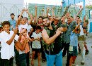 A Palestinian guerrilla fires from his rifle, as children dance around him at Ain al-Hilweh refugee camp near the port city Sidon in south Lebanon September 11, 2001. Palestinians in Lebanon met news of attacks on American targets on Tuesday with jubilant gunfire, dancing and cheering, saying Israel's chief backer deserved such a punishment. (Ali Hashisho/Reuters)