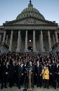 Members of the U.S. Congress bow their heads in silent in memory of the victims of the terrorist attacks during a ceremony at the U.S. Capitol September 11, 2001. The triple terror attacks in New York and Washington forced the first mandatory evacuation of the U.S. Capitol building and sent congressional leaders into a safe but secret location. Lawmakers were told at a late afternoon briefing that the House would reconvene at 10 a.m. Wednesday, according to California Democratic Rep. Maxine Waters. There was no immediate word on when the Senate would return but congressional aides said they expected a similar schedule.  (Win McNamee/Reuters)