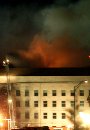 Flames are seen after dark from the Pentagon hours after a hijacked airliner crashed into the building September 11, 2001. The plane smashed into the building, setting off a huge explosion and fire and causing untold casualties in a devastating blow to the headquarters of the U.S. military. The attack, coinciding with similar incidents at the World Trade Center in New York, set off an immediate security alert in the American capital, with all federal buildings evacuated and F-16 fighter jets scrambled overhead. (Molly Riley/Reuters)