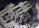 A group of firefighters search the remains of the destroyed World Trade Center in New York on September 11, 2001. Two hijacked U.S. commercial planes slammed into the twin towers of the World Trade Center early on Tuesday, causing both 110-story landmarks to collapse in thunderous clouds of fire and smoke. REUTERS/Shannon Stapleton