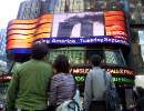 People in Times Square watch the World Trade Center fire live on large screen televisions in New York on September 11, 2001. Two hijacked U.S. commercial planes slammed into the twin towers of the World Trade Center early on Tuesday, causing both 110-story landmarks to collapse in thunderous clouds of fire and smoke. REUTERS/Shannon Stapleton