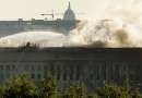 The U.S. Capitol is seen behind the Pentagon as it continues to burn September 12, 2001, a day after a highjacked airliner crashed into the building. Three hijacked planes crashed into major U.S. landmarks September 11, destroying both of New York's mighty twin towers and plunging the Pentagon in Washington into flames, in an unprecedented assault on key symbols of U.S. military and financial power.   REUTERS/Molly Riley