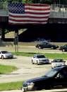 A large American flag hangs from an expressway overpass on Chicago's Kennedy Expressway, September 12, 2001, one day after the attack by terrorists on New York City and Washington.  REUTERS/Sue Ogrocki