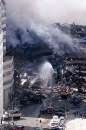 Firefighters pour water on the wreckage of 7 World Trade Center, in New York City early September 12, 2001. 7 World Trade Center collapsed a few hours after both of the landmark  World Trade Center towers imploded after being struck by airliners in a terrorist attack on September 11.  REUTERS/Mike Segar