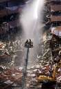 New York City firefighters pour water on the wreckage of 7 World Trade Center in New York City early September 12, 2001. 7 World Trade Center was destroyed along with both the landmark WorldTrade Center towers after being struck by planes in a terrorist attack on September 11.  REUTERS/Mike Segar