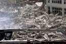 Workers dig in the wreckage of the World Trade Center as it lies accross West Street in New York City  September 12, 2001. The World Trade Center towers were destroyed after being struck by commercial planes in a terrorist attack on September 11.  REUTERS/Mike Segar