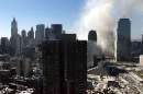 Smoke fills the sky in lower Manhattan as the remains of the World Trade Center smolder September 12, 2001. The landmark World Trade Center towers were destroyed after being struck by two planes in a terrorist attack on Spetember 11.  REUTERS/Mike Segar