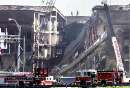 A fire truck sits in front of the damaged area of the Pentagon Building as fire fighters and rescue workers continue to battle smoke at the U.S. Military Headquarters outside of Washington, September 12, 2001. The Pentagon and the World Trade Center Buildings in New York City were attacked yesterday after terrorists hijacked commercial jetliners and crashed them into the buildings.  REUTERS/Larry Downing